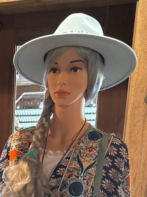 Light blue felt fedora with braided trim, styled on a mannequin wearing a printed summer dress.