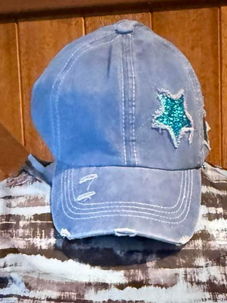 Distressed denim-blue ponytail baseball cap with teal sequin star patch