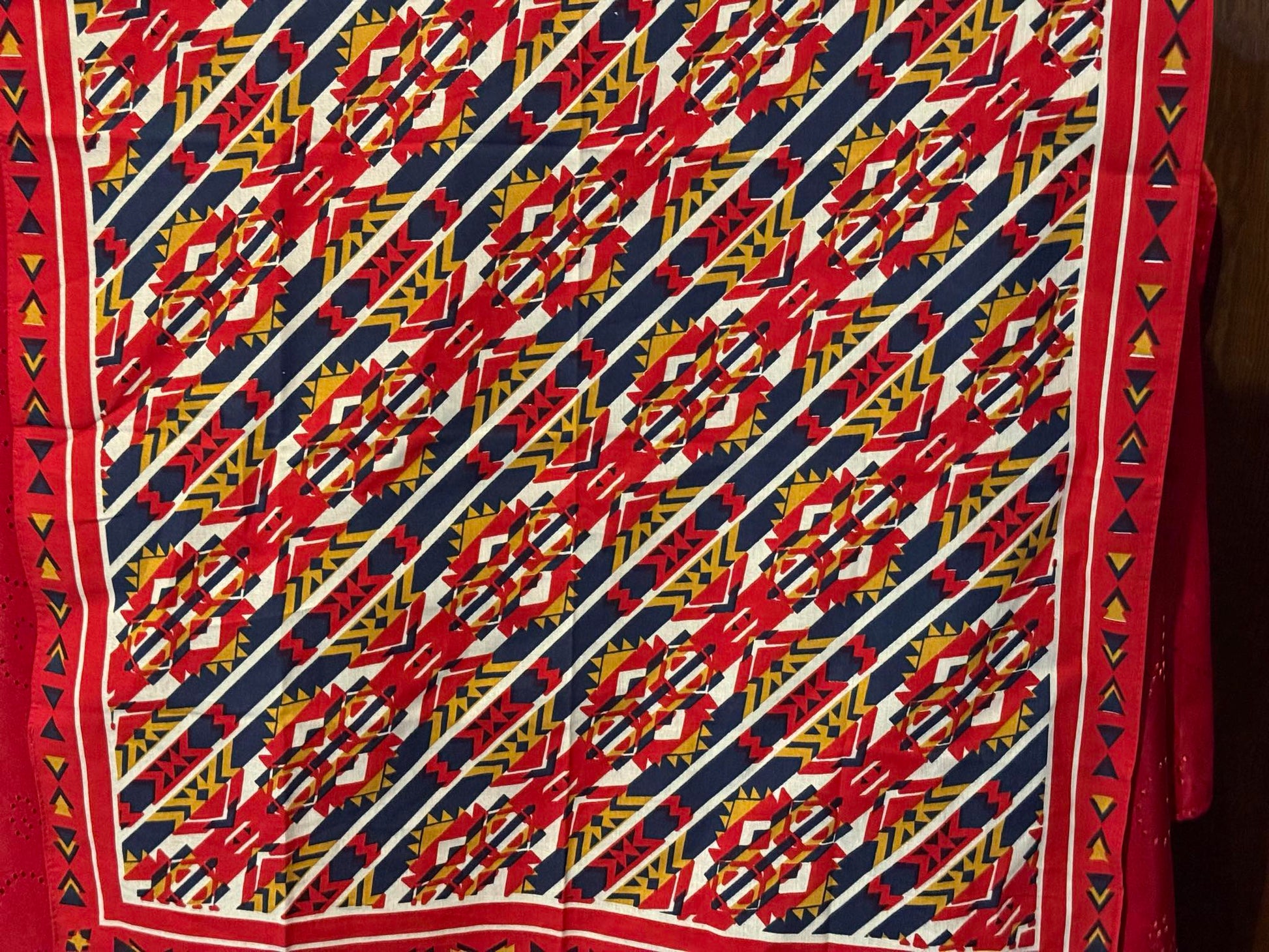 Bright red, blue, and gold cowboy scarf with a bold southwestern geometric pattern.