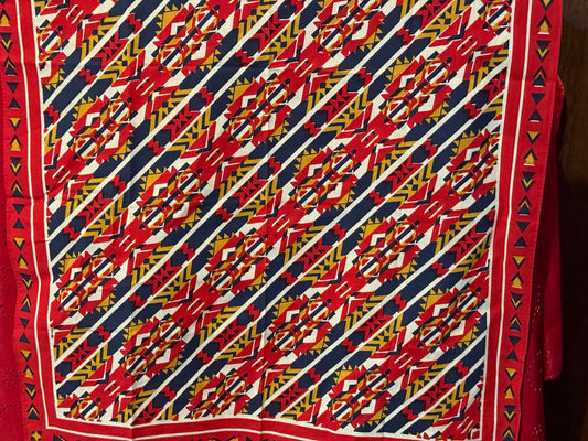 Bright red, blue, and gold cowboy scarf with a bold southwestern geometric pattern.