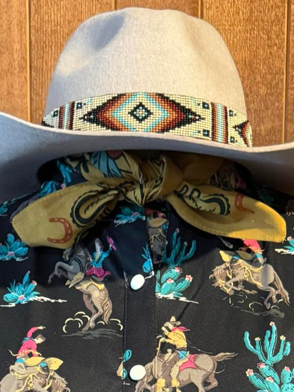 Western-style olive green cotton scarf with vintage paisley print tied around the neck of a mannequin.