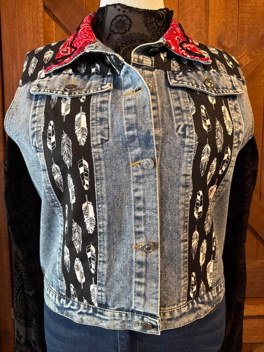 Hand-embellished denim jacket with black and white feather-print fabric panels and red bandana collar, designed by Cindy Owen in Brooksville, Florida.