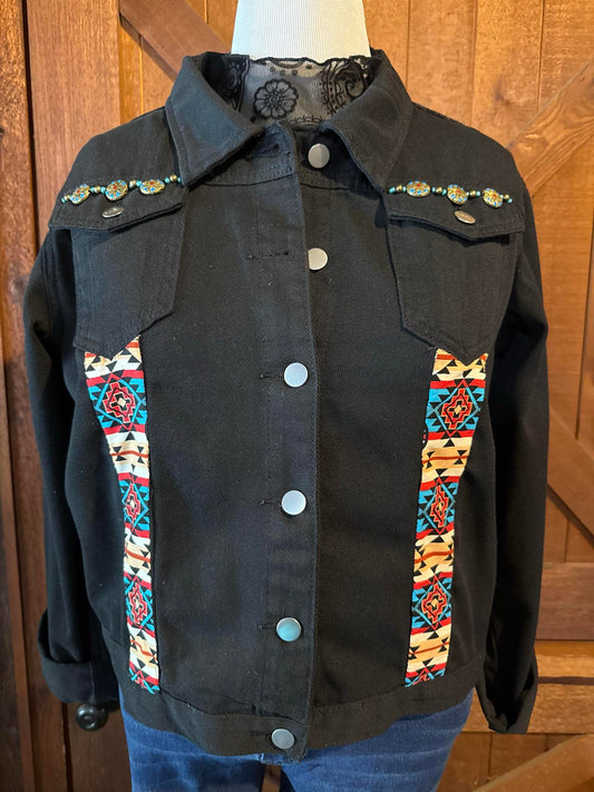 Hand-embellished black denim jacket with vibrant Aztec print panels, turquoise beaded accents, and silver snap buttons. One-of-a-kind design in size XXL.