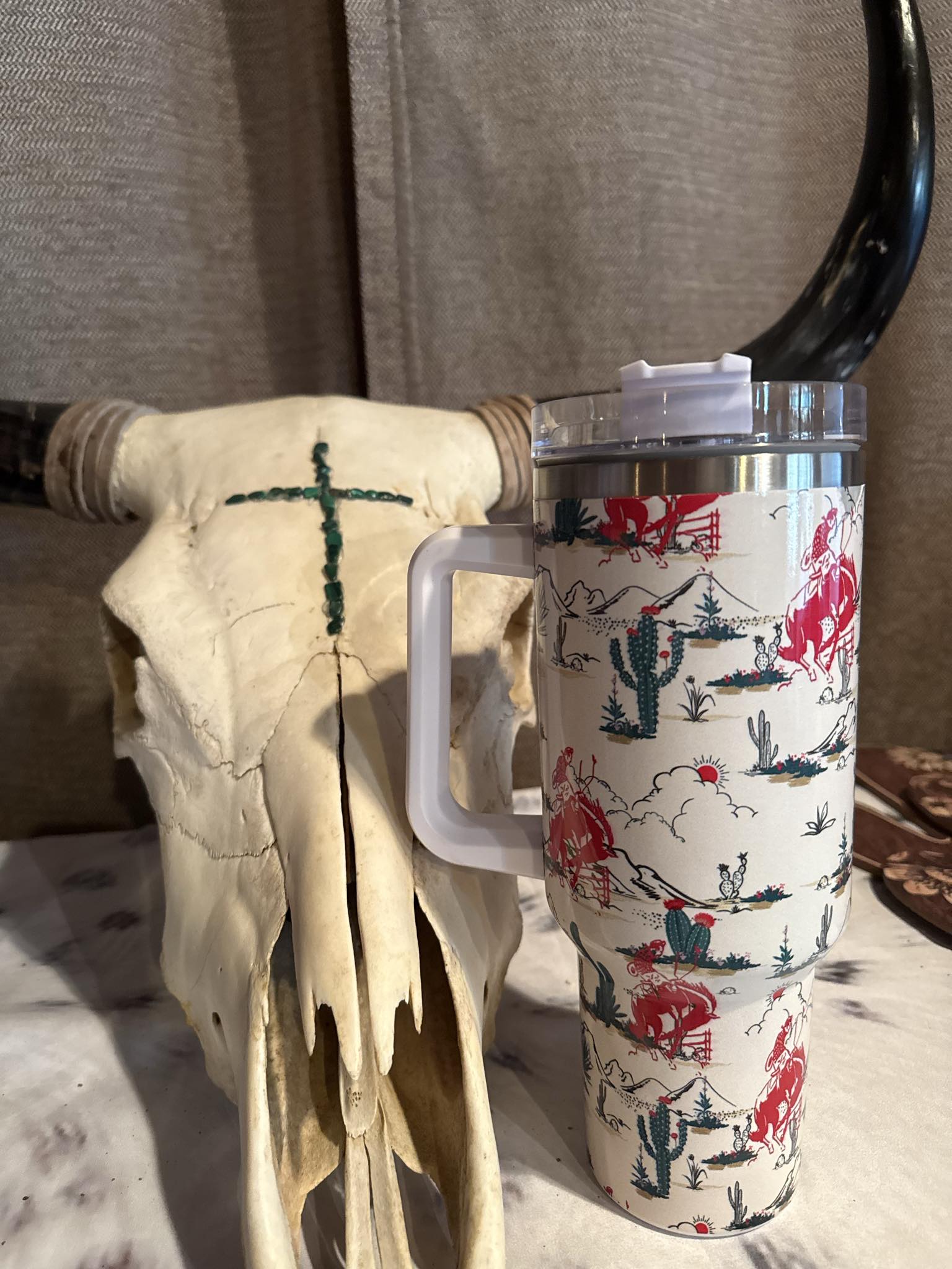 Western-style 40oz tumbler featuring red and navy cowboy rodeo graphics with cacti and desert scenery