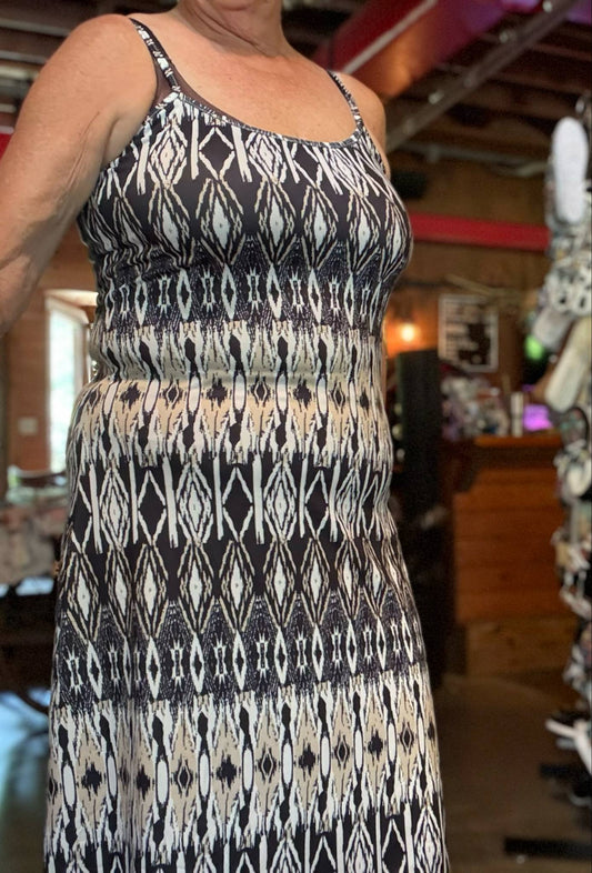 Soft black and cream geometric-print maxi dress with stretchy straps and a flowy fit, shown styled with coverups and button-down tops