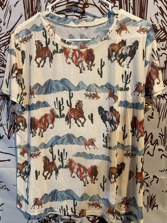 Short-sleeved cream mesh shirt featuring a watercolor-style desert scene with galloping horses, mountains, and cacti.